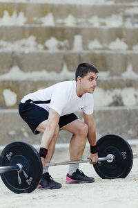 Weightlifter lifting weights in an urban environment.