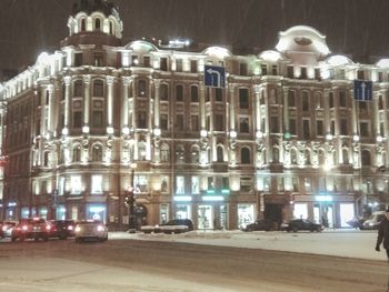 Illuminated building in city at night