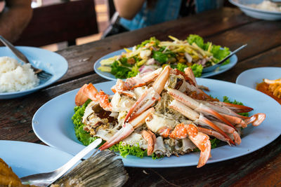 Close-up of crab legs on plate on table