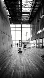 People sitting on wooden floor in building