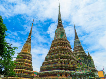 Low angle view of temple building against cloudy sky