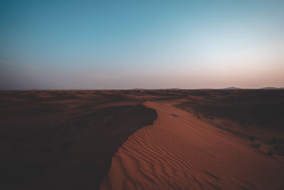 Scenic view of desert against sky during sunset