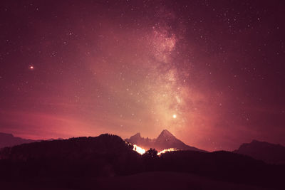 Scenic view of silhouette mountains against sky at night