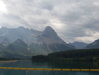 Scenic view of lake by mountains against sky