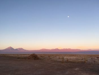 Scenic view of mountains against clear blue sky