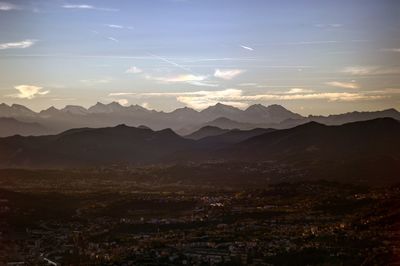 Scenic view of mountains against sky at sunset