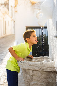 Side view of boy blowing bubbles