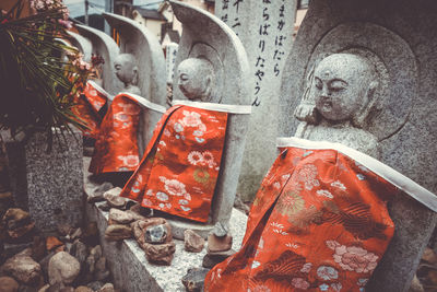 Close-up of buddha statue in cemetery