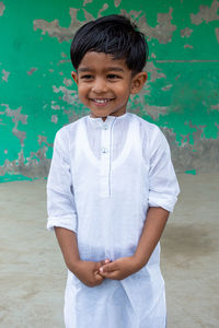 Portrait of smiling boy standing outdoors