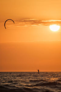 Scenic view of sea against orange sky