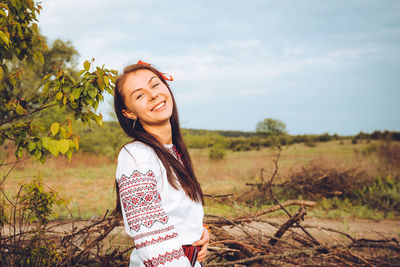 Photo of a smiling young woman in ethnic ukrainian shirt