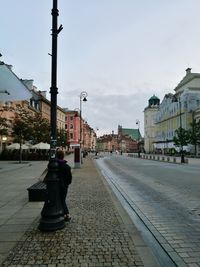 Woman on railroad track in city