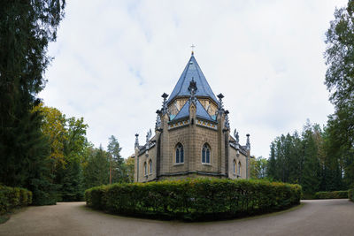 Temple by building against sky