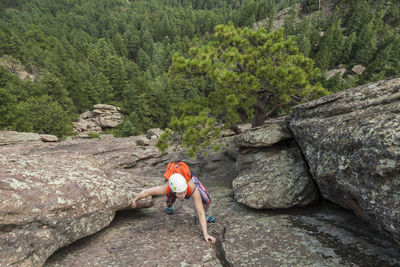 Woman climbs second flatiron without rope above boulder, colorado