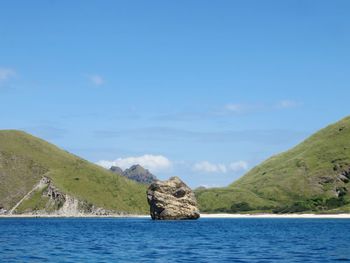 Scenic view of sea and mountains against sky