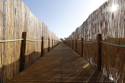 Walkway footbridge against clear sky