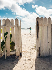 People at beach against sky