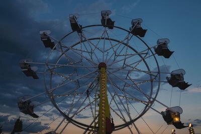 Low angle view of ferris wheel against blue sky