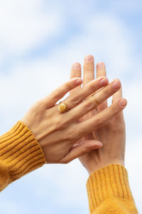 Cropped hand of person with hands against white background