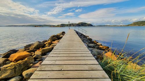 Pier over sea against sky