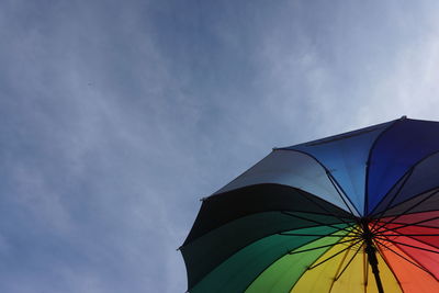 Low angle view of multi colored umbrella against sky