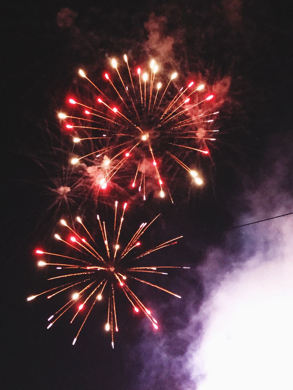 firework display, firework - man made object, exploding, celebration, night, long exposure, arts culture and entertainment, sparks, event, low angle view, illuminated, glowing, motion, smoke - physical structure, firework, blurred motion, multi colored, sky, outdoors, no people, sparkler