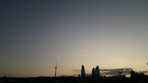 Silhouette of buildings against sky during sunset