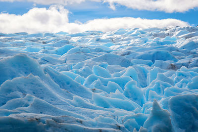 View of glacier in sea against sky