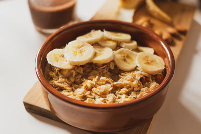 Close-up of breakfast on table. oat porridge with banana, almonds and cocoa