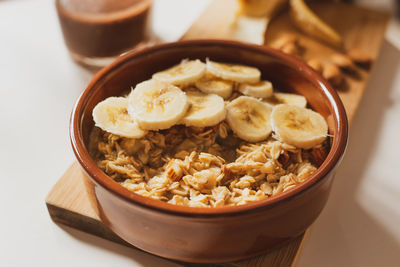 Close-up of breakfast on table. oat porridge with banana, almonds and cocoa