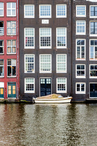 Canal by building in city