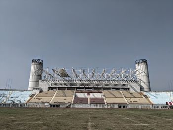 Low angle view of building on field against clear sky