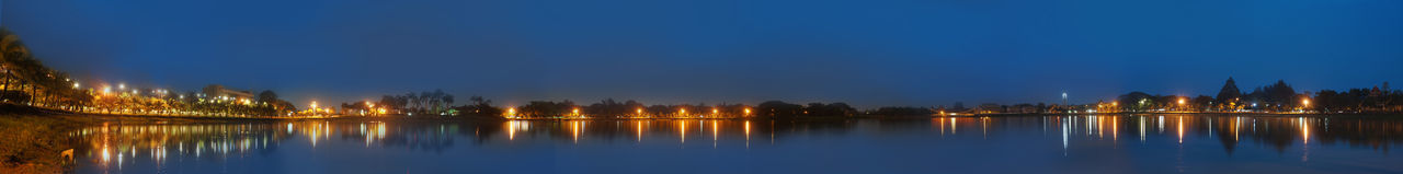 Scenic view of lake against blue sky at night