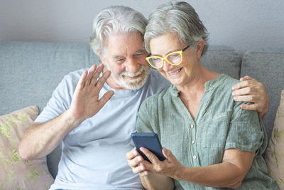 Portrait of a smiling young man using mobile phone