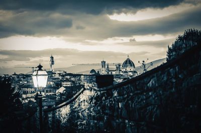 Cityscape against cloudy sky