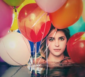 Portrait of woman with colorful balloons