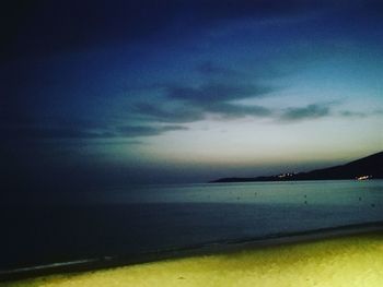 Scenic view of sea against dramatic sky during sunset