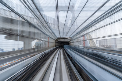 Blurred motion of railroad tracks in subway station