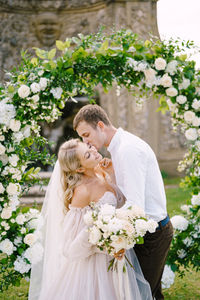 Newlywed couple embracing outdoors