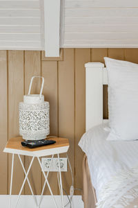 Close-up of the hotel room with white linens and white bathrobes on the bed