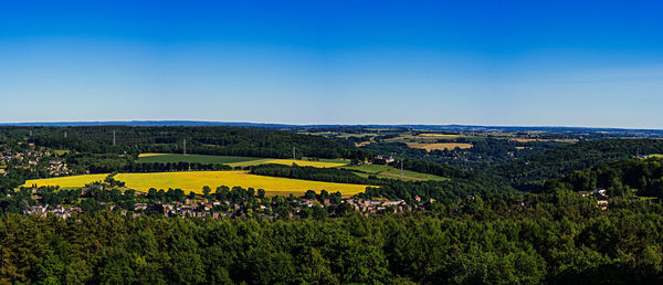 Scenic view of field against blue sky