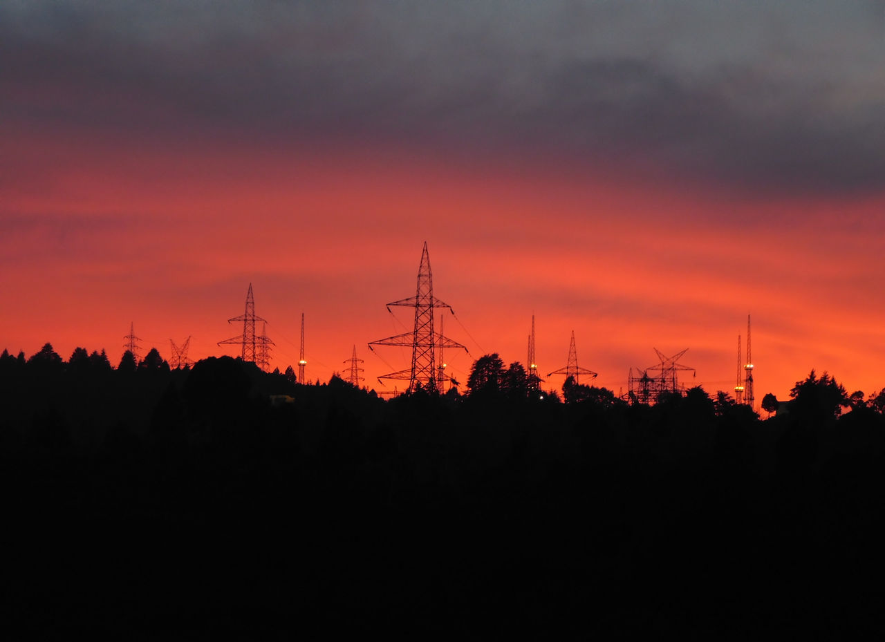 SILHOUETTE ELECTRICITY PYLONS AGAINST SKY DURING SUNSET