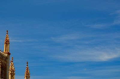 Low angle view of buildings against blue sky