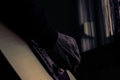 Close-up of hands playing guitar