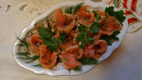 High angle view of salad with salmon in plate on table