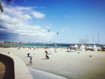 People on beach against sky