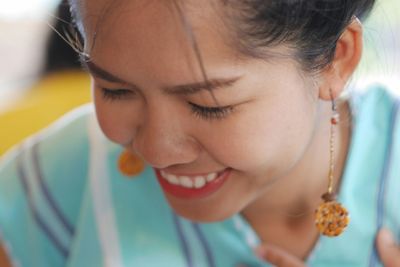 Close-up of happy woman wearing earrings