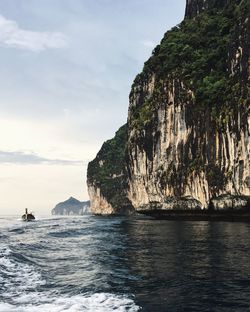 Rock formations by sea against sky