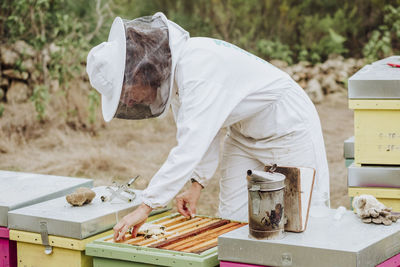 A young woman beekeeper working