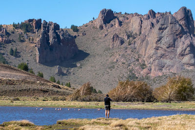 Rear view of man standing on mountain